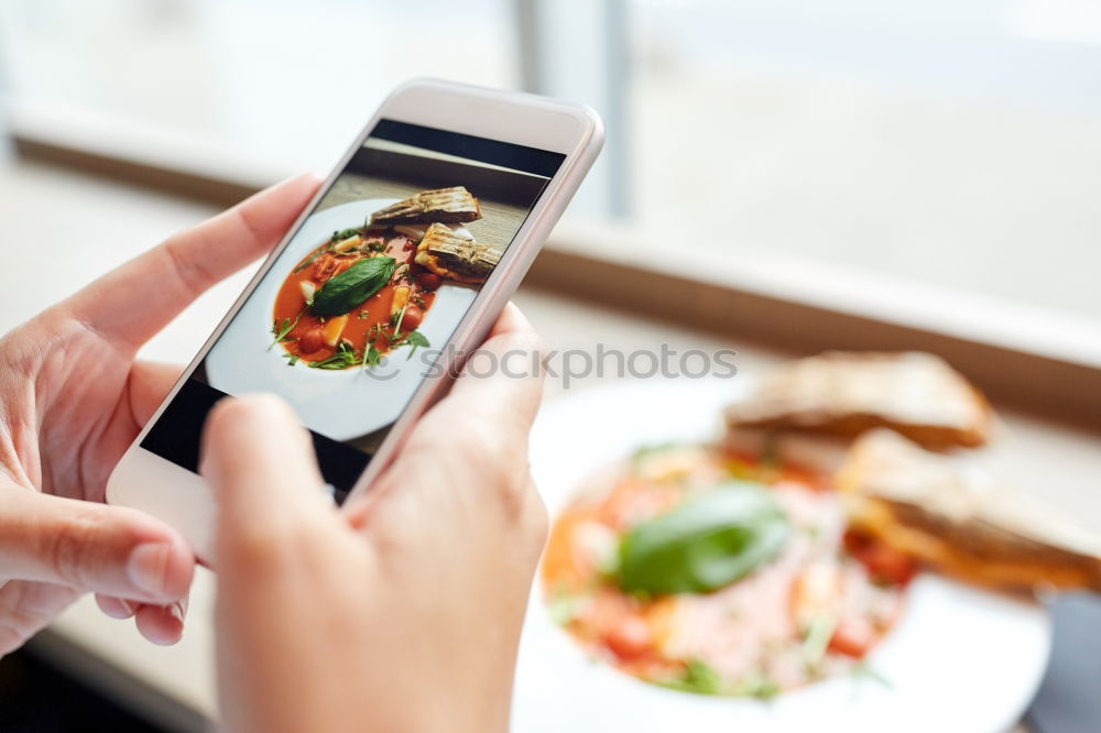 Similar – Image, Stock Photo Hand with smartphone mobile phone, photo of Burger on table