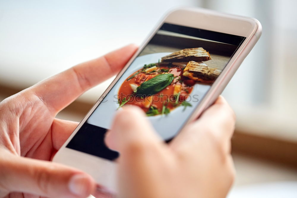 Image, Stock Photo Hand with smartphone mobile phone, photo of Burger on table