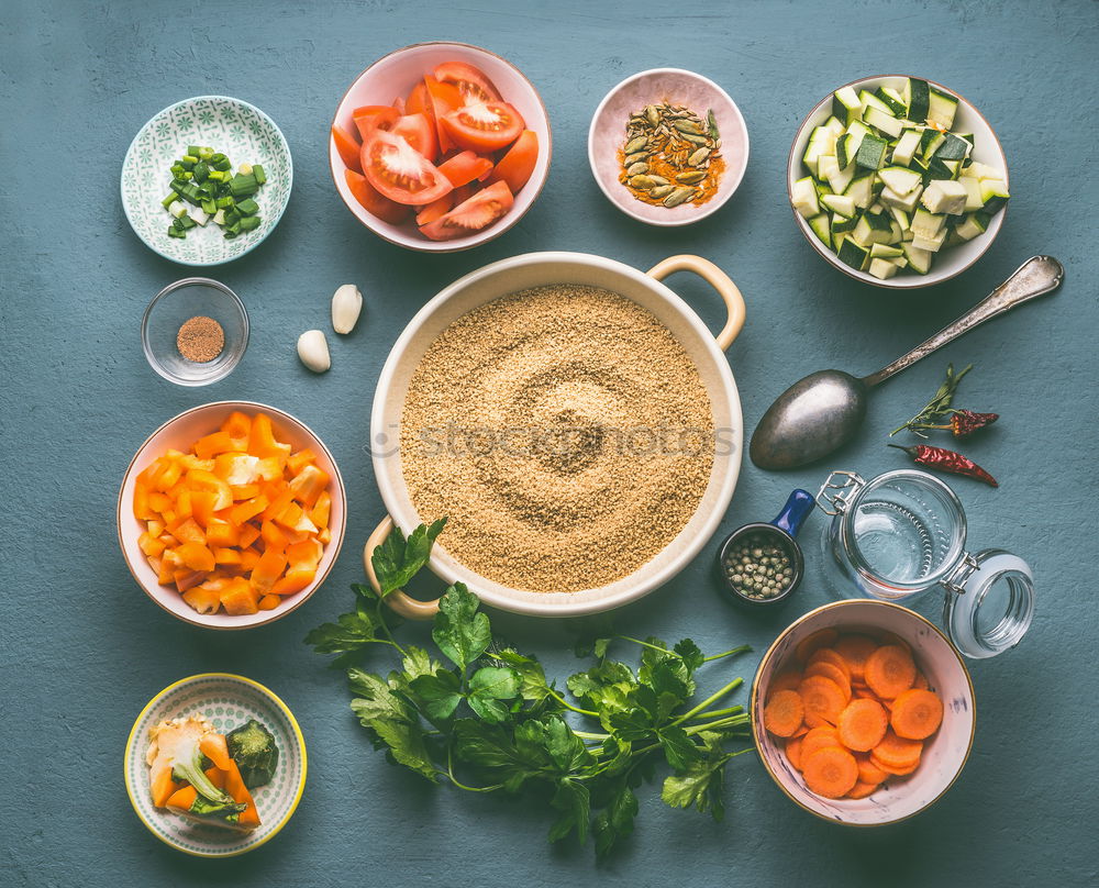 Couscous with vegetable ingredients in bowls