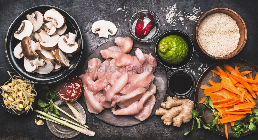 Asian cooking ingredients with rice, chicken and vegetables