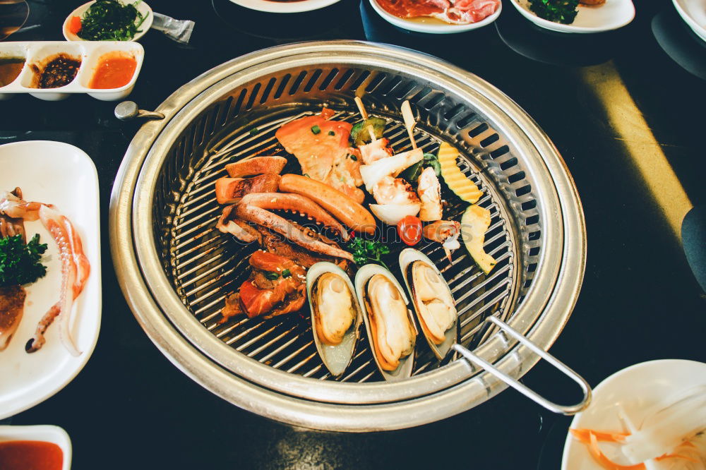 Similar – Korean hot pot and people taking food with chopsticks.