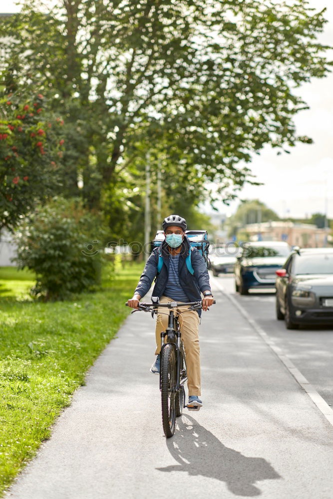 Similar – Handsome afro man walking with his bike.