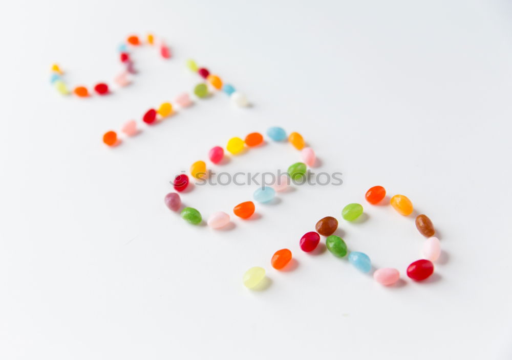 Similar – Image, Stock Photo Number 3 laid out of small chocolate candies with colored sugar sprinkles on white background