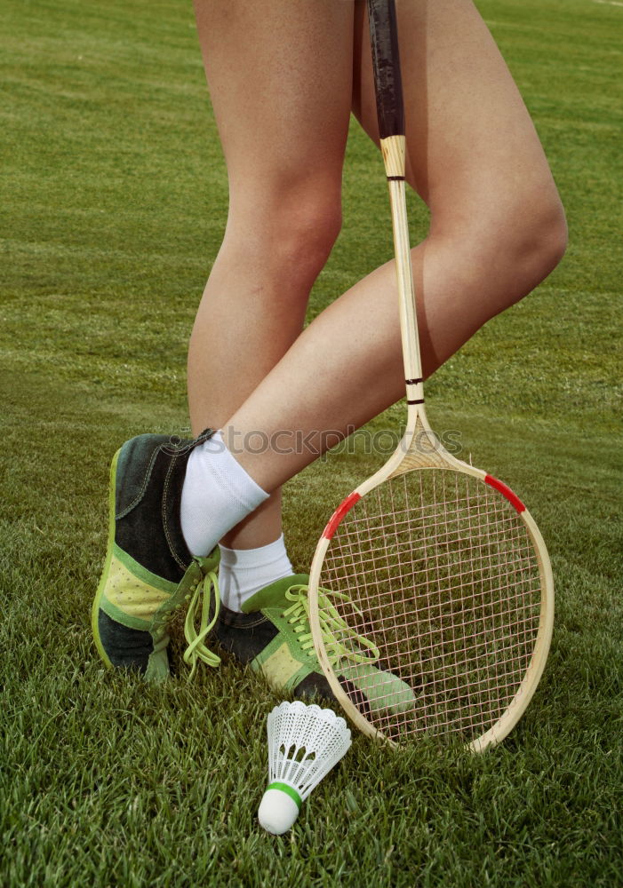 Similar – a badminton ball is lying on a badminton racket in the grass