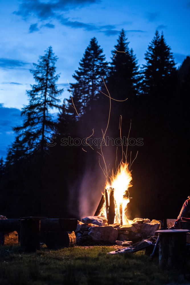 Similar – Image, Stock Photo Man lights a fire in the fireplace in nature at night