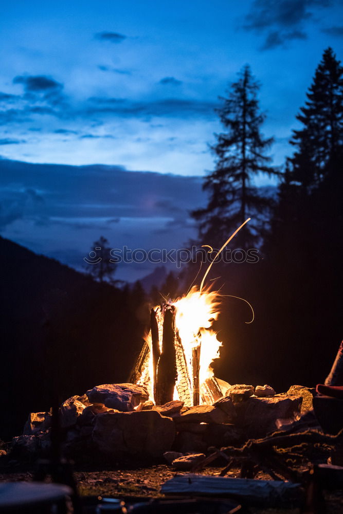 Similar – Man lights a fire in the fireplace in nature at night