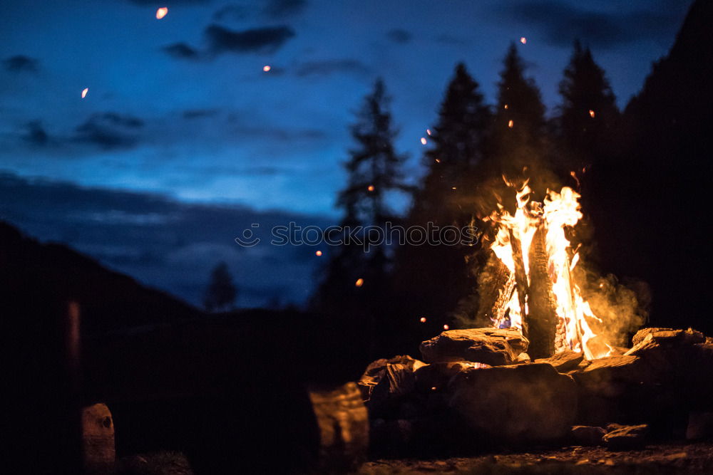 Similar – Image, Stock Photo Man lights a fire in the fireplace in nature at night