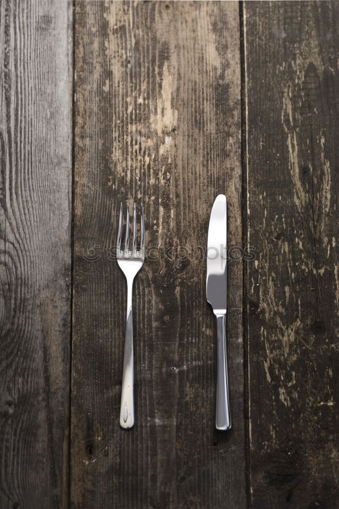 Similar – Image, Stock Photo Wooden spoon and fork on gray napkin