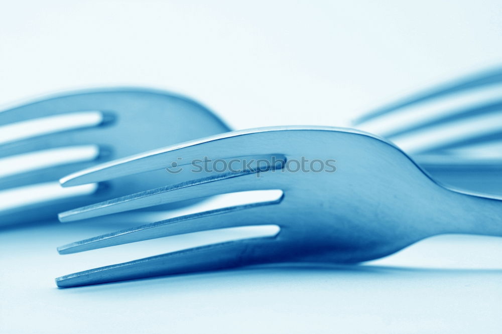 Disposable plastic cutlery on blue background. Top view