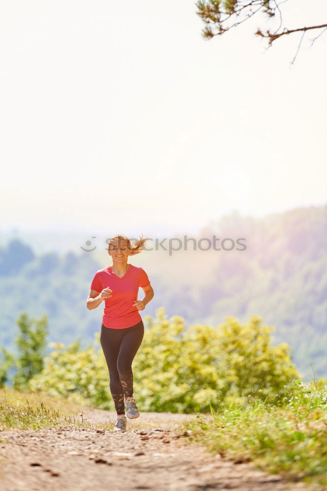 Similar – Cheerful woman running through field