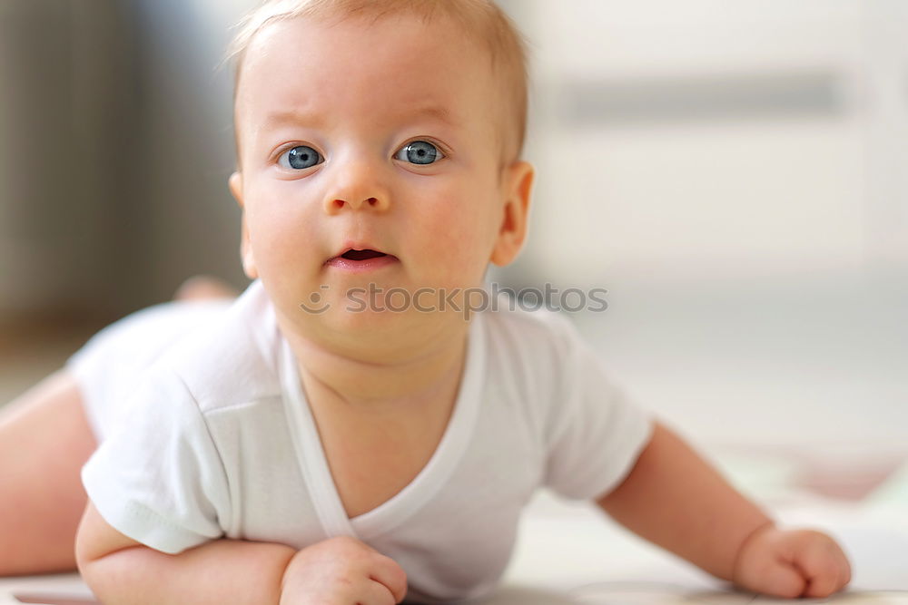 Similar – Happy baby girl, four months old, on the bed with pacifier.