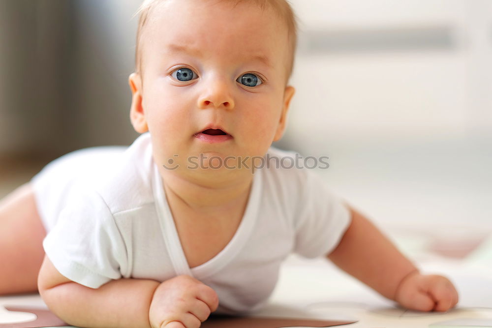 Similar – Happy baby girl, four months old, on the bed with pacifier.