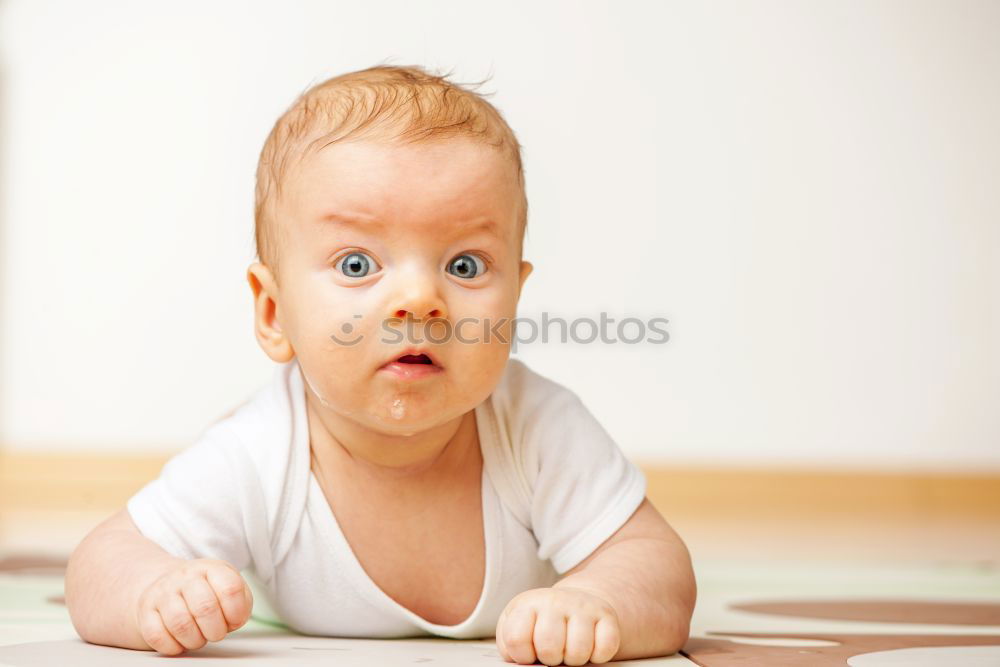 Similar – Happy baby girl, four months old, on the bed with pacifier.