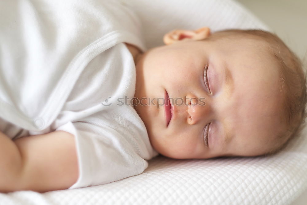 Similar – The back of a baby’s head lying on its stomach