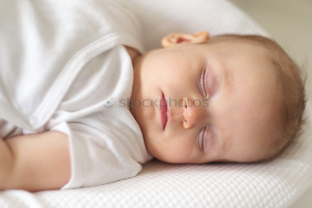 Similar – Adorable baby sleeping wrapped in a red blanket