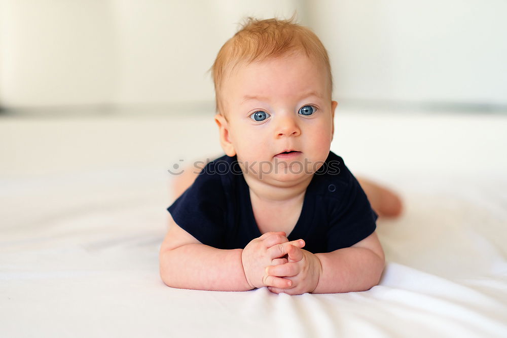 Similar – Happy baby girl, four months old, on the bed with pacifier.