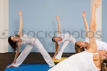 Similar – Group of young sporty sexy women in yoga studio, practicing yoga lesson with instructor, forming a line in Adho mukha svanasana downward dog asana pose. Healthy active lifestyle, working out in gym