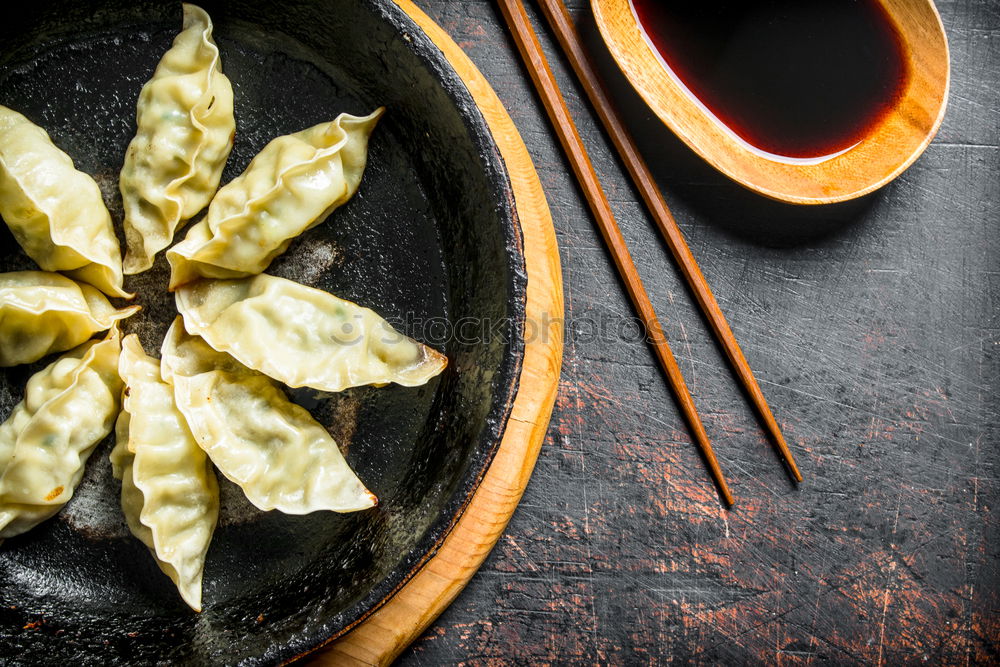 Similar – Dumplings or gyoza served in traditional steamer