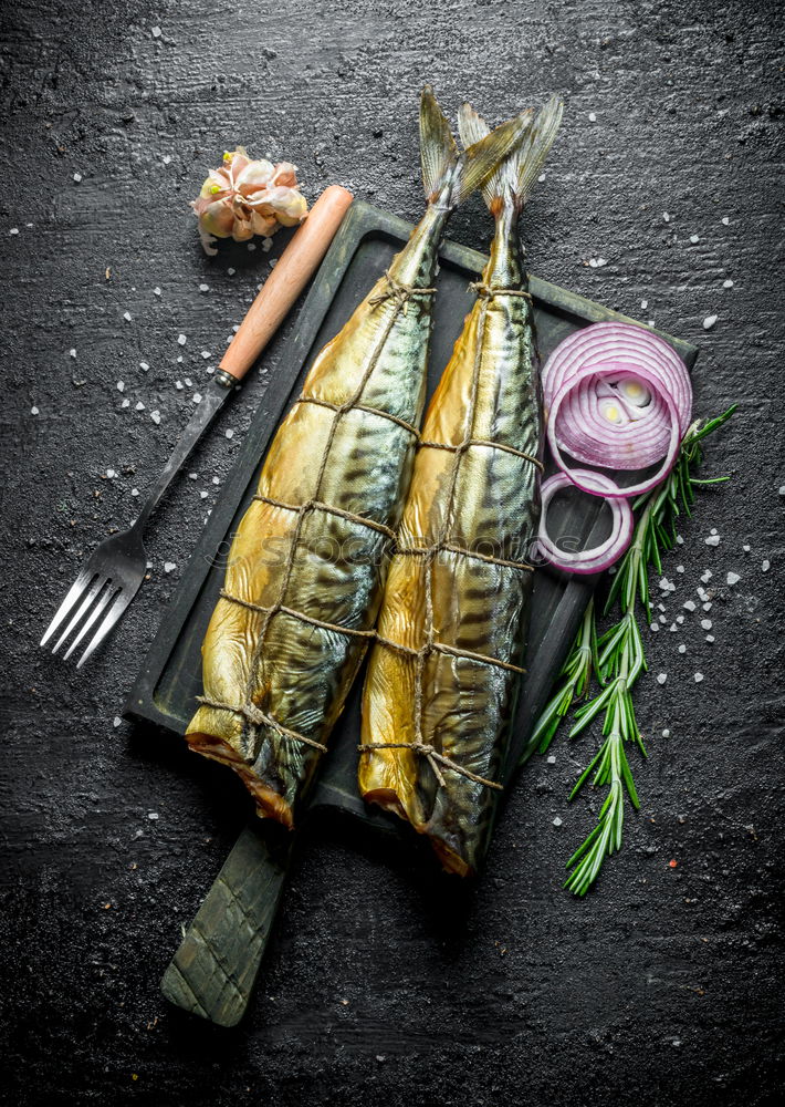 Similar – Image, Stock Photo Grilled sardines on baking tray with ingredients: lemon, garlic and herbs for tasty seafood eating. Cooking preparation of fishes