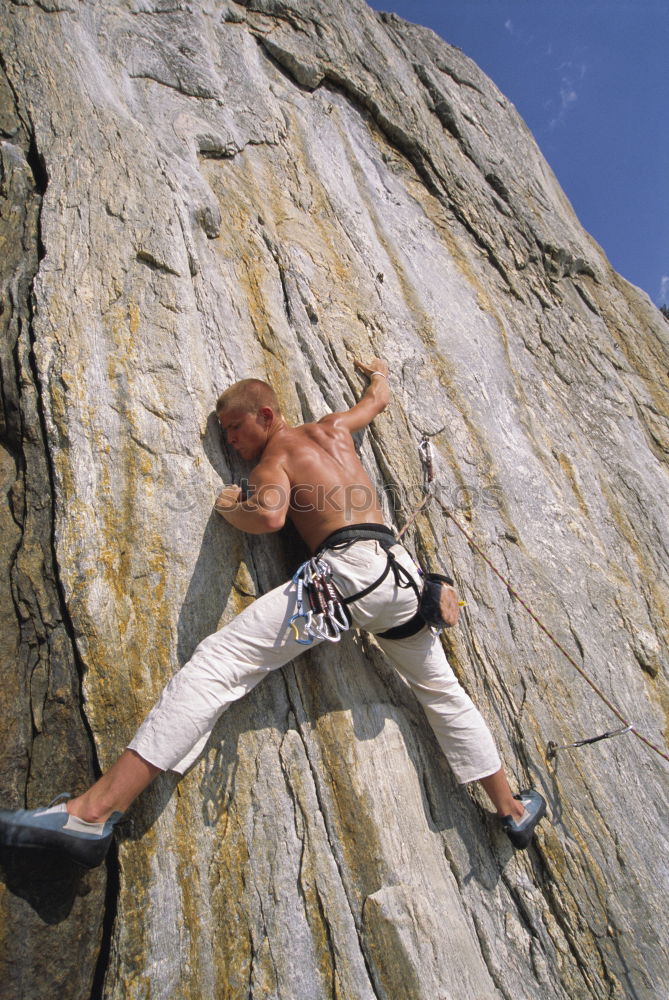 Similar – Rock climber clinging to a cliff.