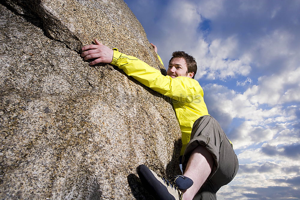 Similar – Rock climber clinging to a cliff.