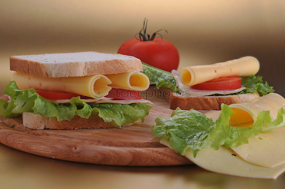 Similar – Homemade breakfast: bread with cheese, ham and lettuce, with app