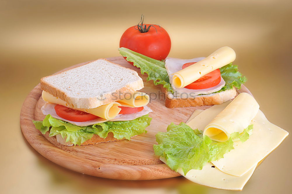 Similar – Homemade breakfast: bread with cheese, ham and lettuce, with app