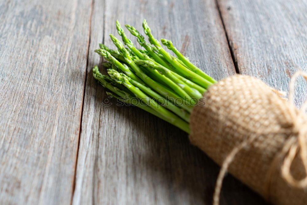 Similar – Image, Stock Photo Fresh raw asparagus spears on a white table