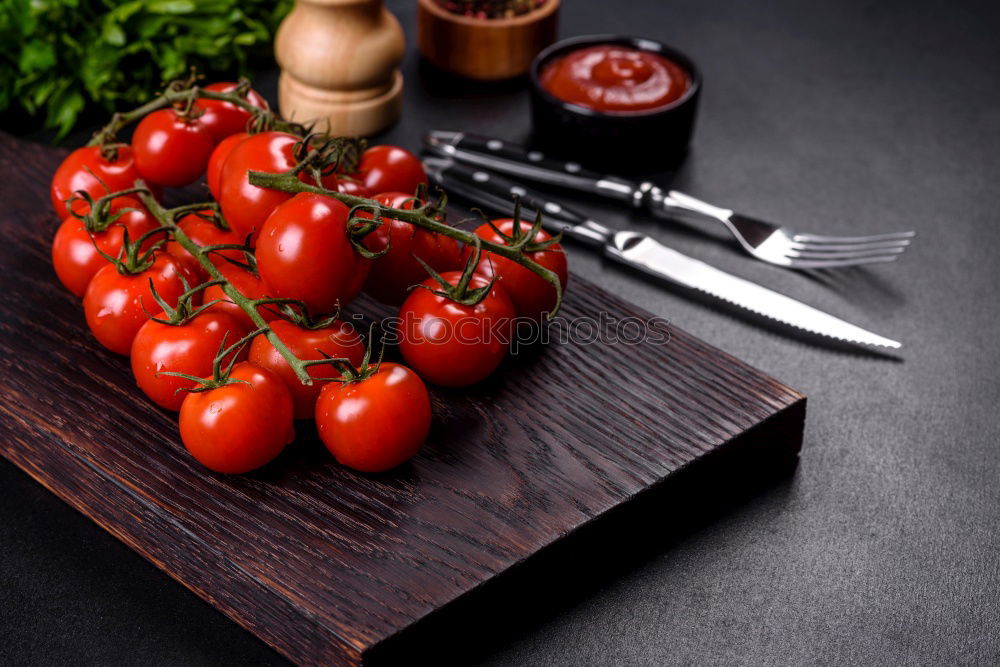 Similar – Image, Stock Photo cutting board with a knife and fresh red cherry tomatoes