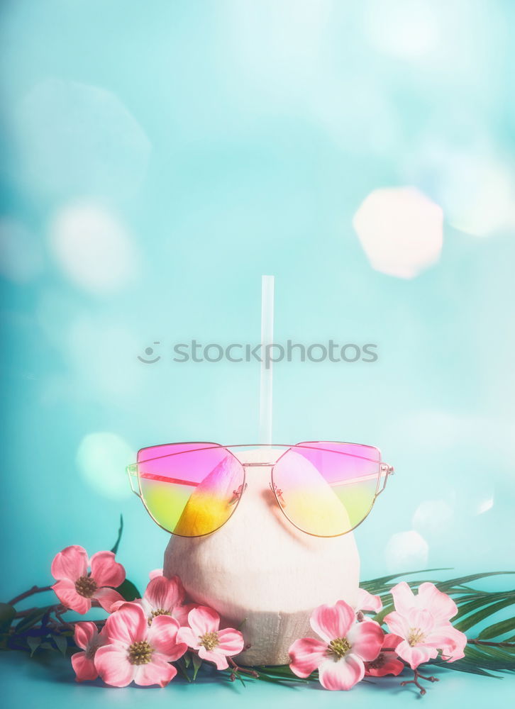 Coconut cocktail with pink sunglasses