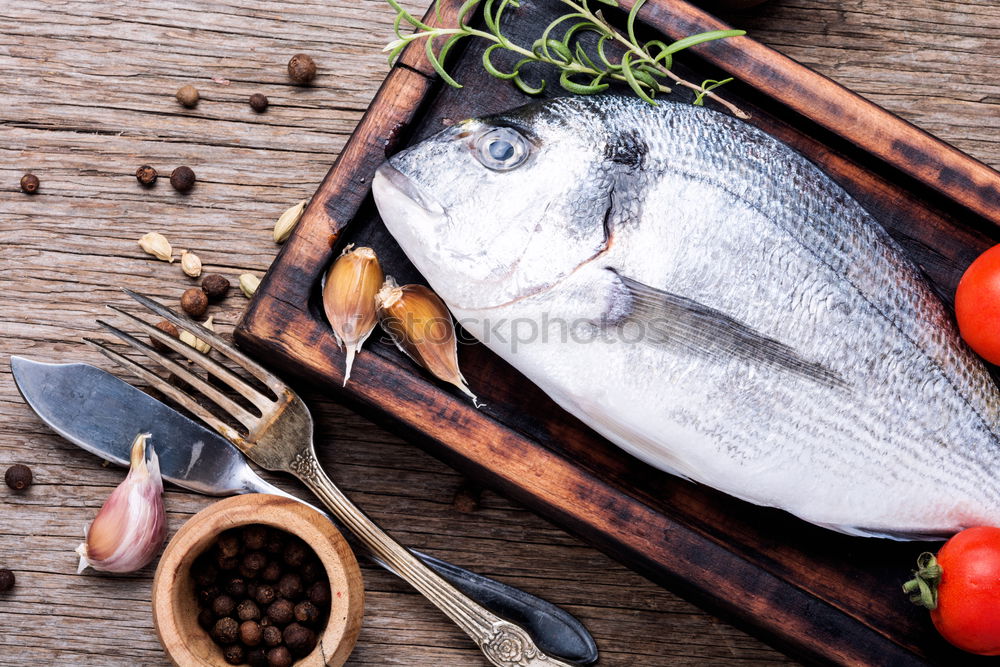 Similar – Image, Stock Photo Two Dorado fish with cooking ingredients