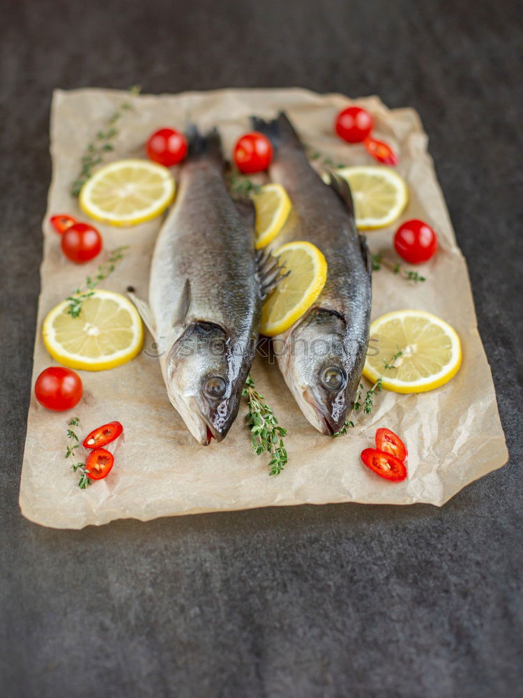 Similar – Image, Stock Photo Sea bass on kitchen table with lemon and rosemary