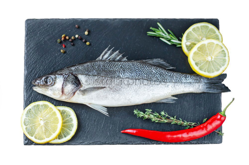 Similar – Image, Stock Photo Sea bass on kitchen table with lemon and rosemary