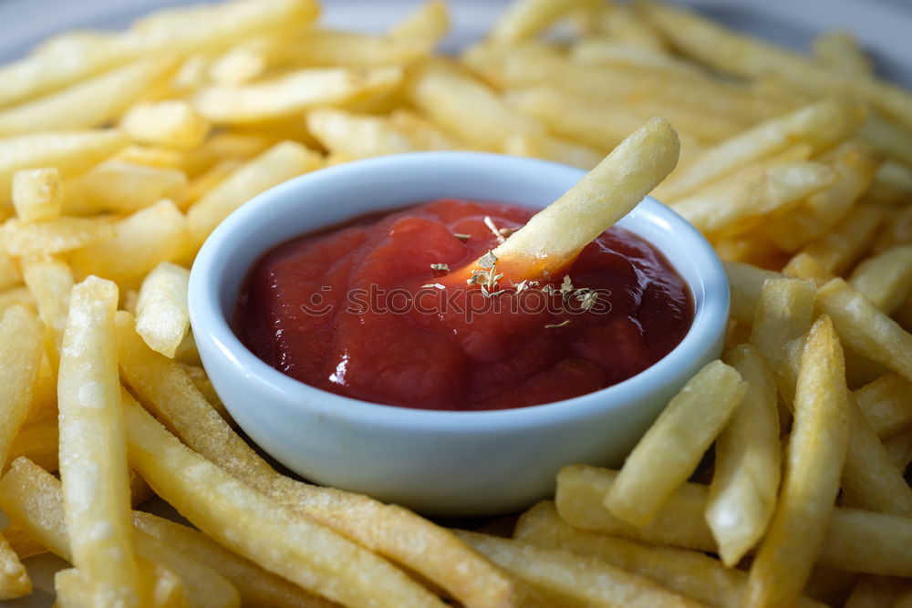 Similar – Foto Bild Portion Pommes mit Mayonnaise in einem Pappschälchen und einer Holzgabel auf einem Holztisch