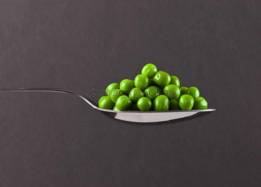 Similar – Image, Stock Photo To the point! A plate with a blue rim, on it many green and a blue ball, dots and a fork on a wooden table