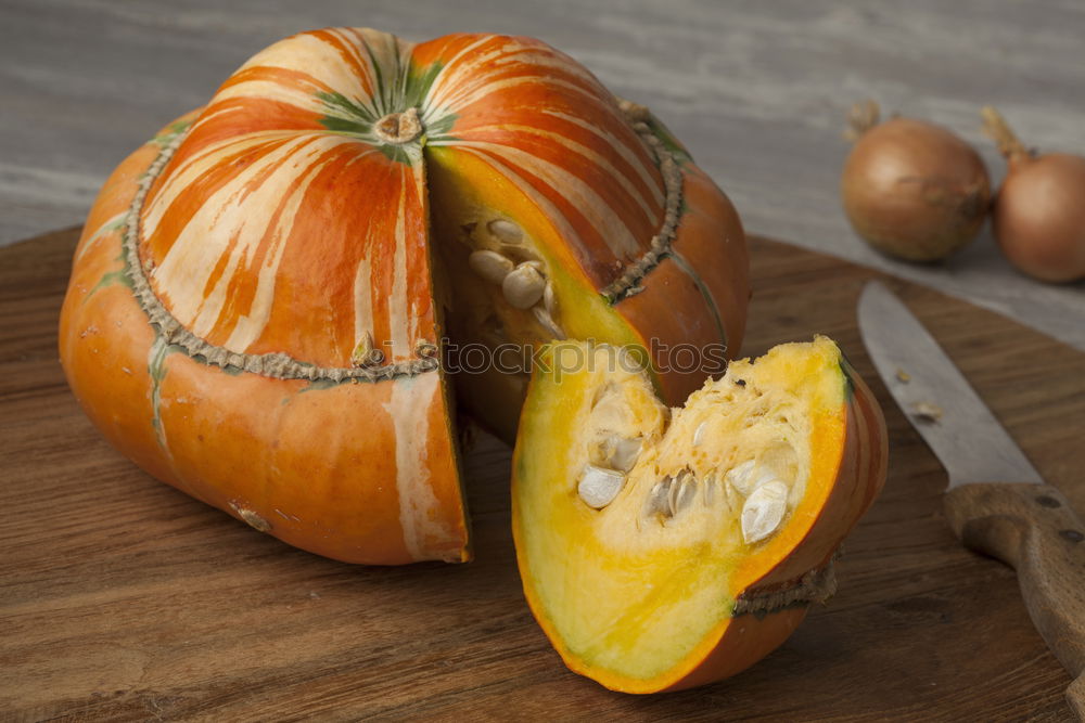 Similar – Image, Stock Photo Half pumpkin with seeds and cooking spoon