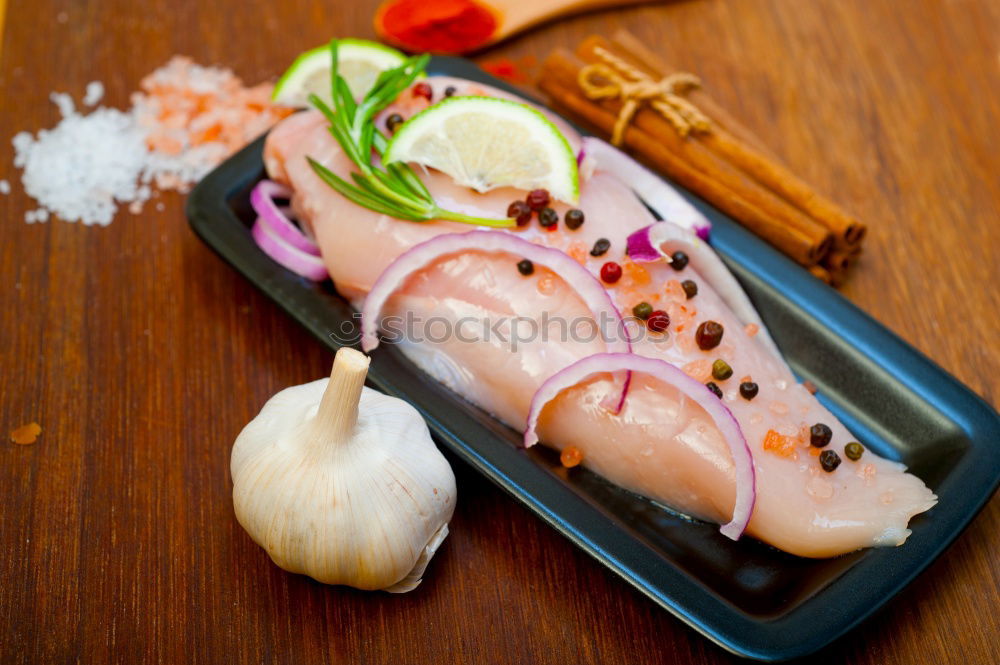 Similar – Red onion and lemon on zander fish