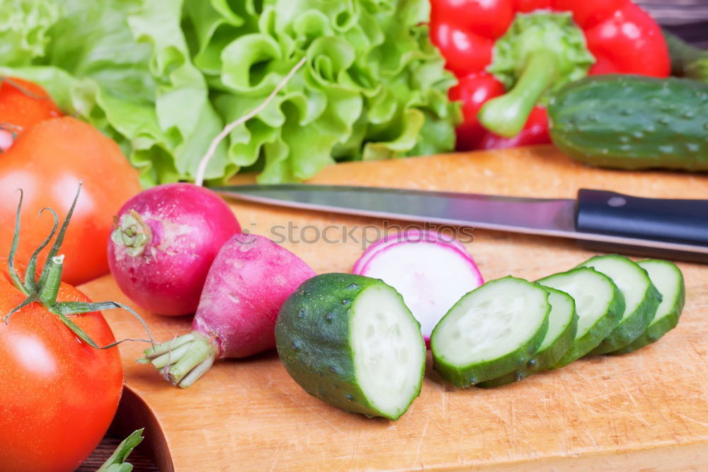 Similar – Image, Stock Photo Tomato and cucumber salad on a kitchen board
