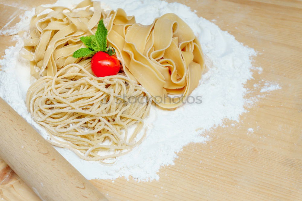 Similar – Image, Stock Photo Making homemade taglatelle with a pasta rolling cutter