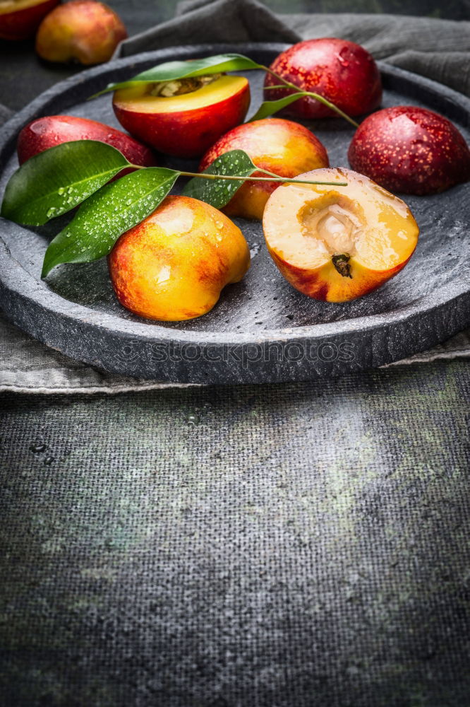 Image, Stock Photo Fresh peaches with green leaves on stone slab