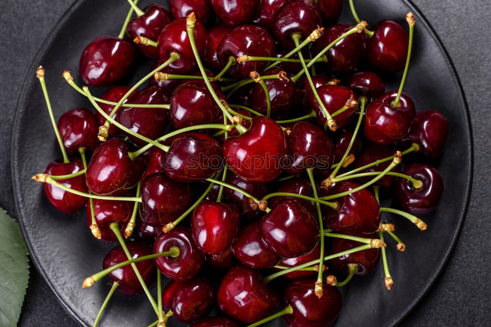 Similar – Sweet cherries in a blue bowl on a dark wooden table