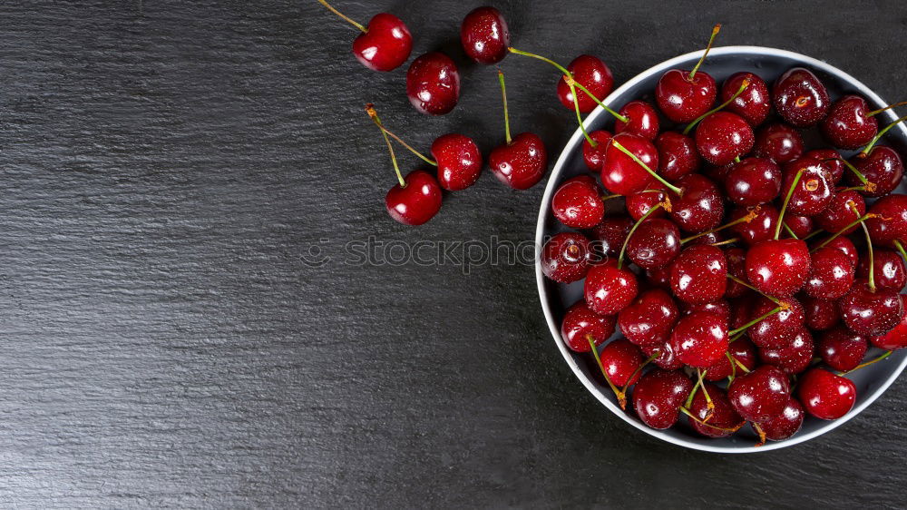 Similar – Sweet cherries in a blue bowl on a dark wooden table