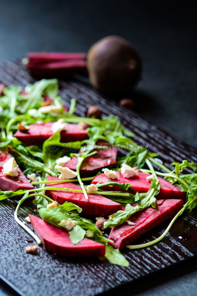 Similar – Healthy green salad with dressing on dark background