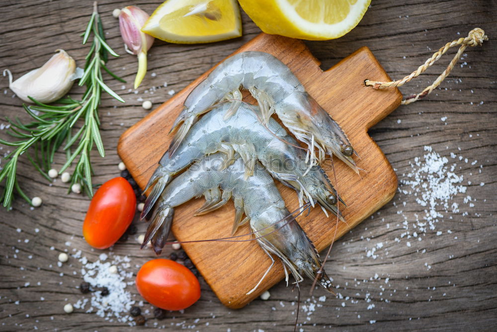 Similar – Image, Stock Photo Fresh smelt fish in spices for cooking on a kitchen board