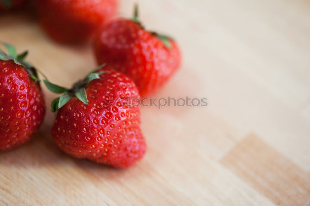 Strawberries on a wooden board with empty space