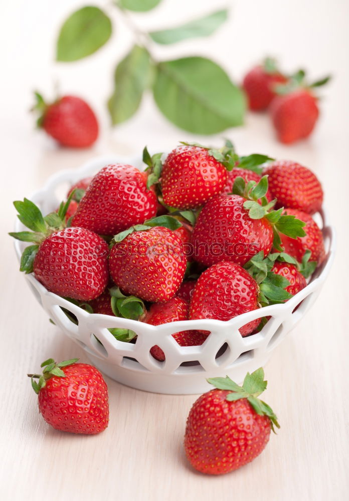 Similar – Strawberries whole and cut on a white wooden table