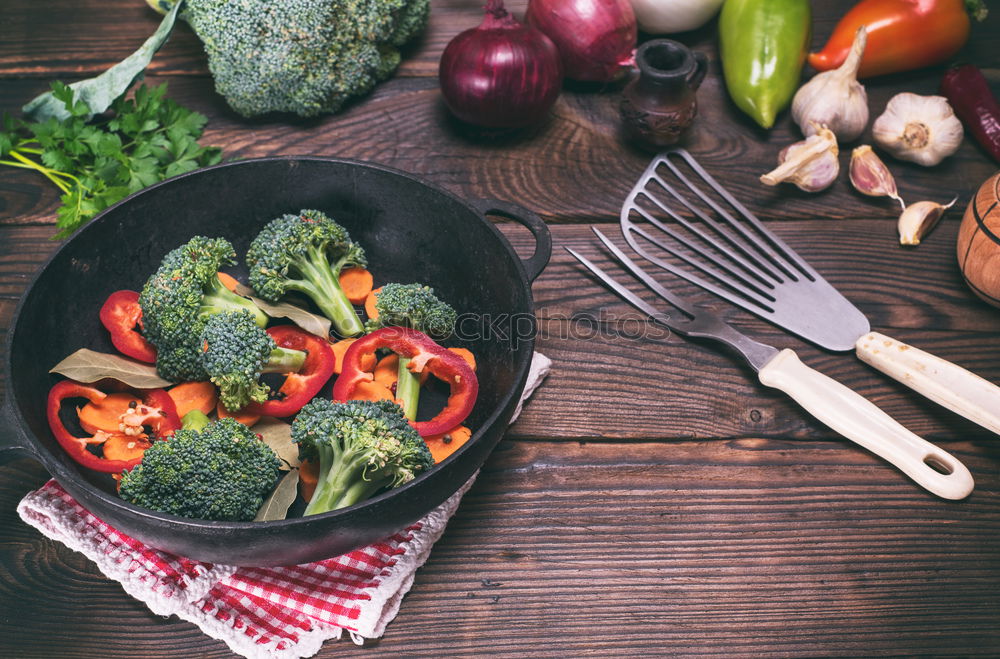 vegetables in a black round frying pan