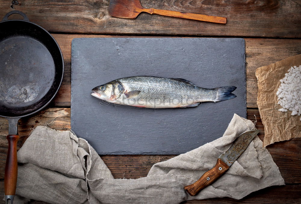 Frozen fish smelt on the kitchen board