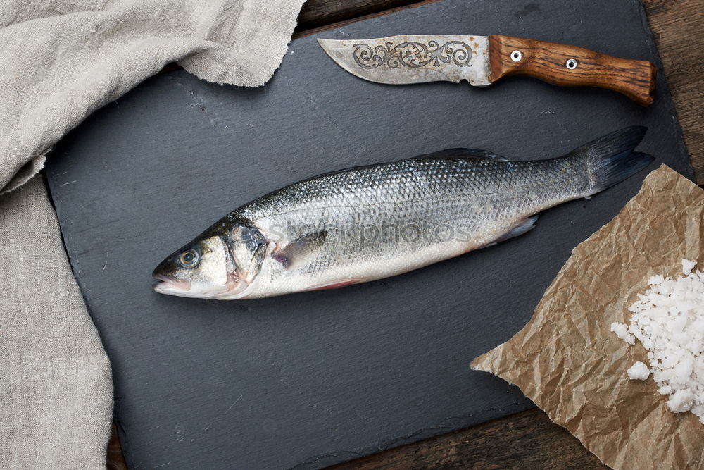 Fresh fish smelt spices for cooking on a kitchen board