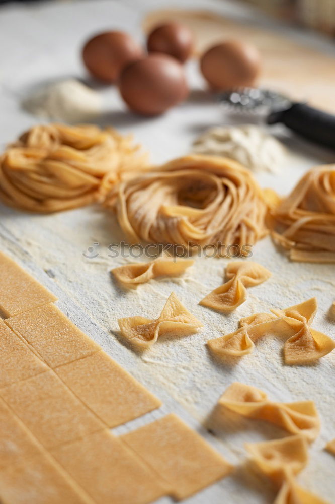 Similar – Image, Stock Photo Making homemade taglatelle with a pasta rolling cutter